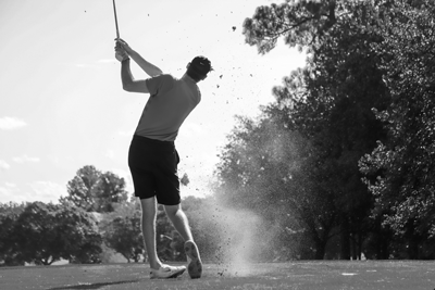 Image of a golfer hitting a golf ball