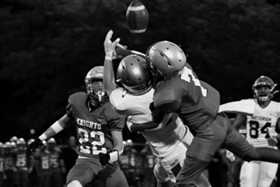 Football players catching a thrown ball